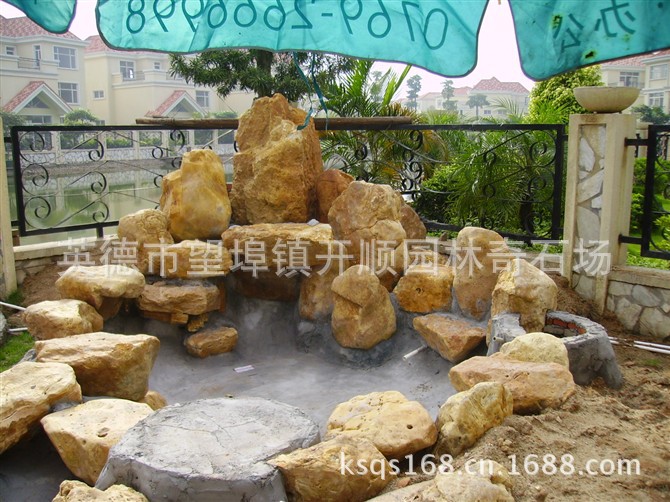 专业设计、制造大小黄腊石假山、黄蜡石鱼池水景